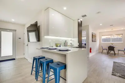 a kitchen with blue stools and a counter top at Fort Lauderdale Vacation Rental about 8 Mi to Beaches! in Fort Lauderdale