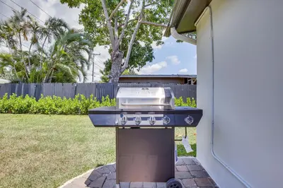 a grill sitting on a barbecue in a yard at Fort Lauderdale Vacation Rental about 8 Mi to Beaches! in Fort Lauderdale