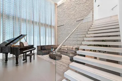 a living room with a piano and a couch at Boardwalk Mansion in Fort Lauderdale