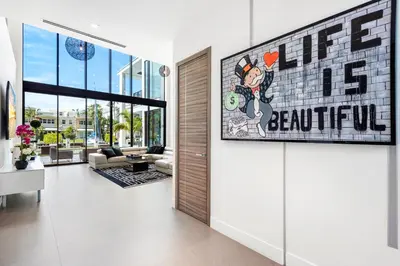 a living room with a sign on the wall at Boardwalk Mansion in Fort Lauderdale