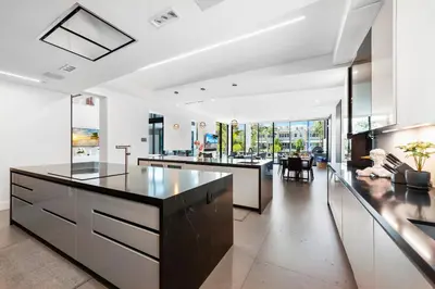 an open kitchen with a large island and a living room at Boardwalk Mansion in Fort Lauderdale