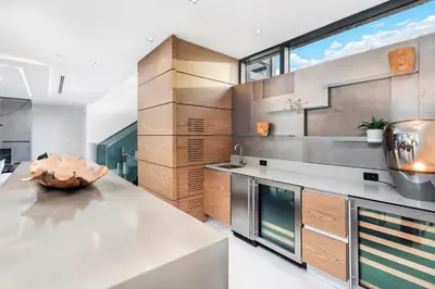 a kitchen with stainless steel appliances and a large window at Park Place Mansion in Fort Lauderdale