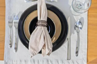 a plate with a napkin on top of a table at Exquisite Modern Marvel in Golden Isles
