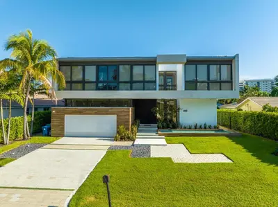 a house with a palm tree in front of it at Exquisite Modern Marvel in Golden Isles