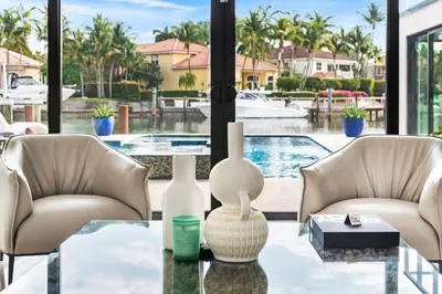 a living room with two chairs and a glass table at Villa Paraiso in Hollywood
