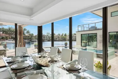 a dining room with a view of the water at Villa Paraiso in Hollywood
