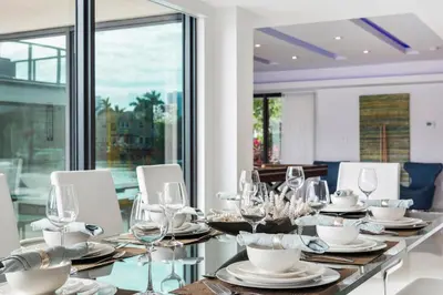 a dining room with a long table with wine glasses at Villa Paraiso in Hollywood