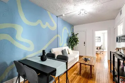a living room with a white couch and a blue wall at Comfy Little Havana Apt - Centrally located Hv2 in Miami