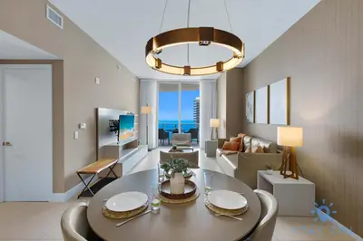 a living room with a dining room table and a chandelier at Upper Level Penthouse - Amazing Views Beach & Intracoastal in Hollywood