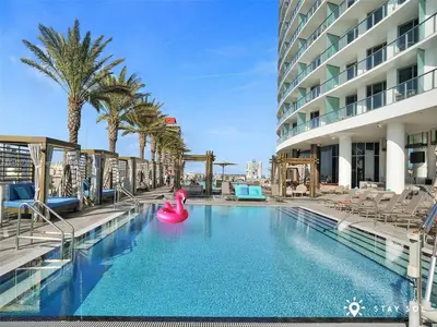 a swimming pool with a pink raft in a hotel at Upper Level Penthouse - Amazing Views Beach & Intracoastal in Hollywood