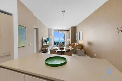 a kitchen and living room with a green plate on a counter at Upper Level Penthouse - Amazing Views Beach & Intracoastal in Hollywood