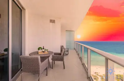a balcony with a table and chairs and the ocean at Rooftop Oceanview Balcony Beachfront Resort in Hollywood