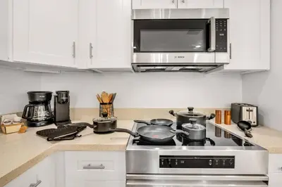 a kitchen with a stove with pots and pans at Urban Seaside in Dania Beach