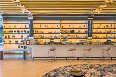 a bar in a room with shelves of wine bottles at Fort Lauderdale Condo with Veranda and Ocean View! in Fort Lauderdale