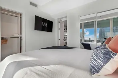 a white bedroom with a bed and a window at 2-Story 3BD Brickell Penthouse Free Parking Heated Pool in Miami