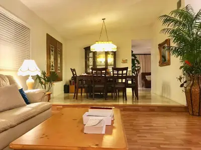a living room with a couch and a table at Pool House in Tropical Miami in Miami