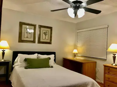 a bedroom with a bed with a ceiling fan at Pool House in Tropical Miami in Miami