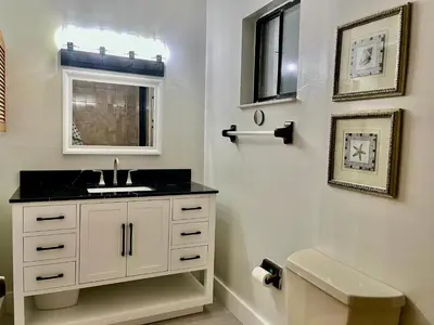 a bathroom with a sink and a mirror at Pool House in Tropical Miami in Miami
