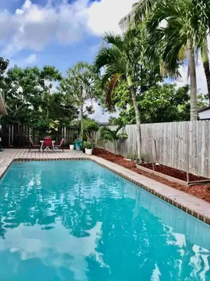 a swimming pool in a yard with palm trees at Pool House in Tropical Miami in Miami