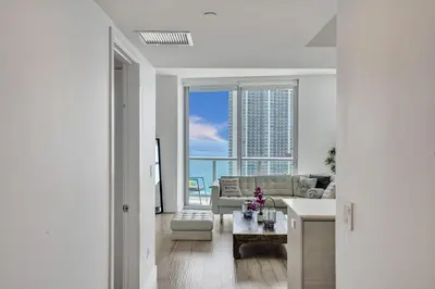 a living room with a couch and a table at Lower Penthouse 3BD 3BA - Beach Pool Gym in Hallandale Beach