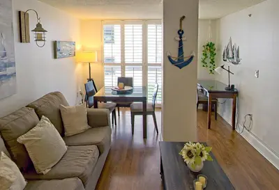 a living room with a couch and a table at 1bed 1bath Steps To Marina & Cocowalk In Grove in Miami