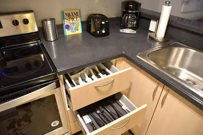 a kitchen with a sink and a counter top at 1bed 1bath Steps To Marina & Cocowalk In Grove in Miami
