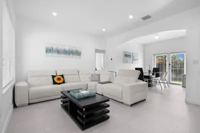 a living room with a white couch and a table at Villa Coco Cozy Home Near Brickell Miami Beach in Miami