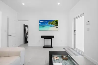 a living room with a white couch and a table at Villa Coco Cozy Home Near Brickell Miami Beach in Miami
