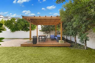 a wooden gazebo with a table and a bench at Villa Coco Cozy Home Near Brickell Miami Beach in Miami