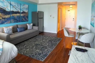 a living room with a couch and a table at Glamorous Bay View Studio In The Heart Of Grove in Miami