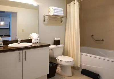 a bathroom with a toilet and a sink and a bath tub at Glamorous Bay View Studio In The Heart Of Grove in Miami