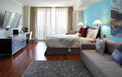 a hotel room with a bed and a couch at Glamorous Bay View Studio In The Heart Of Grove in Miami