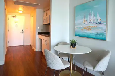 a dining room with a white table and chairs at Glamorous Bay View Studio In The Heart Of Grove in Miami