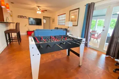 a large foosball table in a living room at HOME AWAY FROM HOME Near Airport and Malls and Highways in South Miami