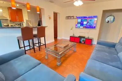 a living room with a couch and a table at HOME AWAY FROM HOME Near Airport and Malls and Highways in South Miami