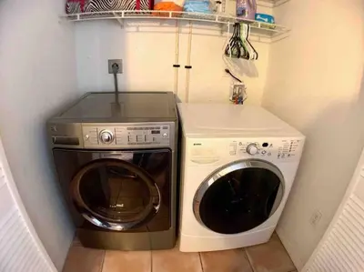 a washing machine and a washer in a small kitchen at HOME AWAY FROM HOME Near Airport and Malls and Highways in South Miami