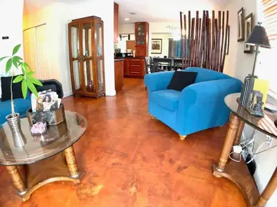 a living room with a blue couch and a table at HOME AWAY FROM HOME Near Airport and Malls and Highways in South Miami