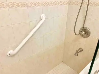 a shower with a hand rail in a bathroom at Home Sweet Home Near Malls and Airport and Hwy in South Miami