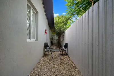 a small hallway with two chairs and a table at Villa Capri Cottage in the heart of Miami in Miami