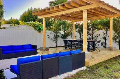 a wooden deck with a pergola and a table and chairs at Villa Gia Large Home Near Brickell Miami Beach in Miami