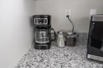 a coffee maker on a counter next to a microwave at Miami Luxury 5BD Home! Next to Wynwood & Design district in Miami