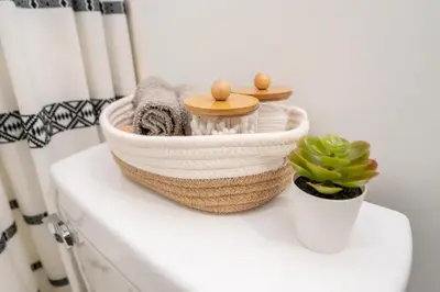 a basket of towels and a plant on a counter at Miami Luxury 5BD Home! Next to Wynwood & Design district in Miami