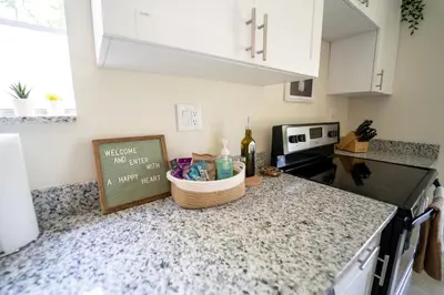 a kitchen with a counter top with a bottle of wine at Miami Luxury 5BD Home! Next to Wynwood & Design district in Miami