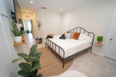 a bedroom with a bed with pillows on it at Miami Luxury 5BD Home! Next to Wynwood & Design district in Miami