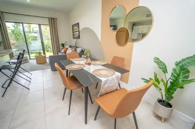 a dining room and living room with a table and chairs at Miami Luxury 5BD Home! Next to Wynwood & Design district in Miami