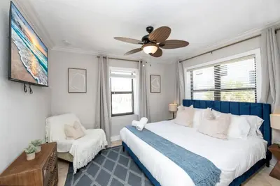 a bedroom with a large bed and a ceiling fan at 311-22 Beachside in Hollywood