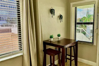 a table and chairs in a room with a window at 311-22 Beachside in Hollywood