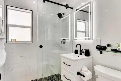 a white bathroom with a sink and a shower at Soleil @ Casa Del Sol in Fort Lauderdale