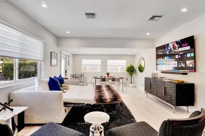 a living room with a couch and a tv at Soleil @ Casa Del Sol in Fort Lauderdale