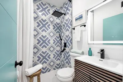 a bathroom with a white toilet and a sink at SOBE Monarch 1 - 2 BEDROOM 2 BATHROOM - MODERN APTS -WALK TO OCEAN DRIVE -2 INDEPENDENT 1 BEDROOM 1 BATHROOM APTS in Miami Beach